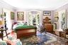 Bedroom with radiator, crown molding, wood finished floors, and arched walkways