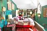 Bedroom featuring wood finished floors, vaulted ceiling, baseboards, and radiator