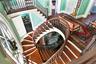 Staircase with wood finished floors and baseboards