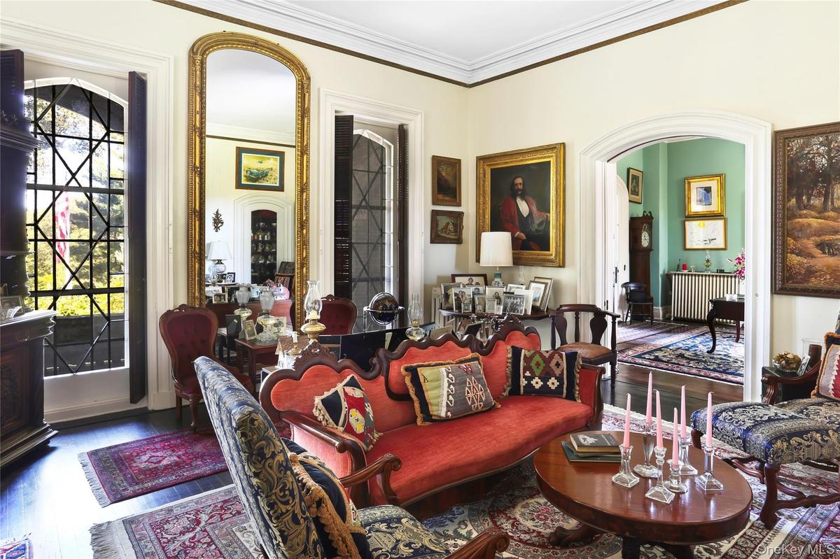 Living area with wood finished floors and ornamental molding