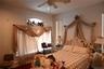 Bedroom with ceiling fan and a baseboard heating unit