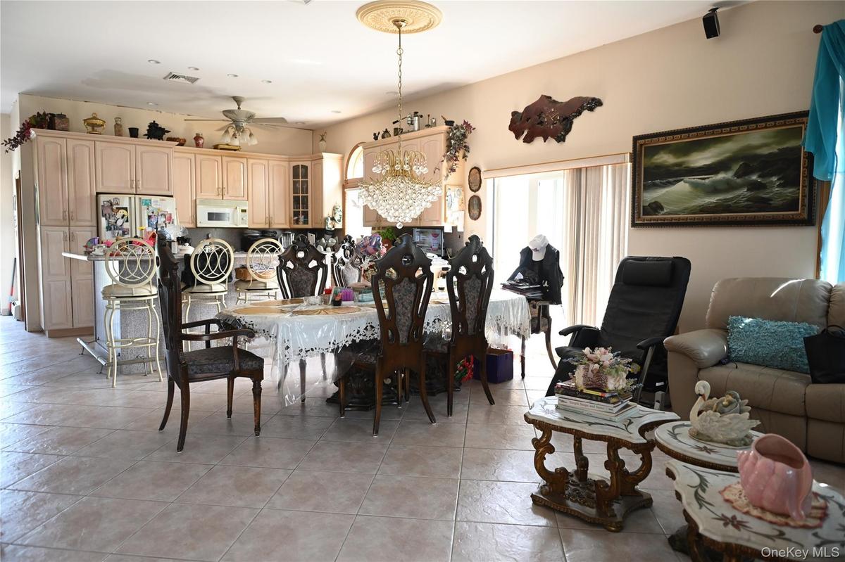 Dining room featuring light tile patterned floors and ceiling fan