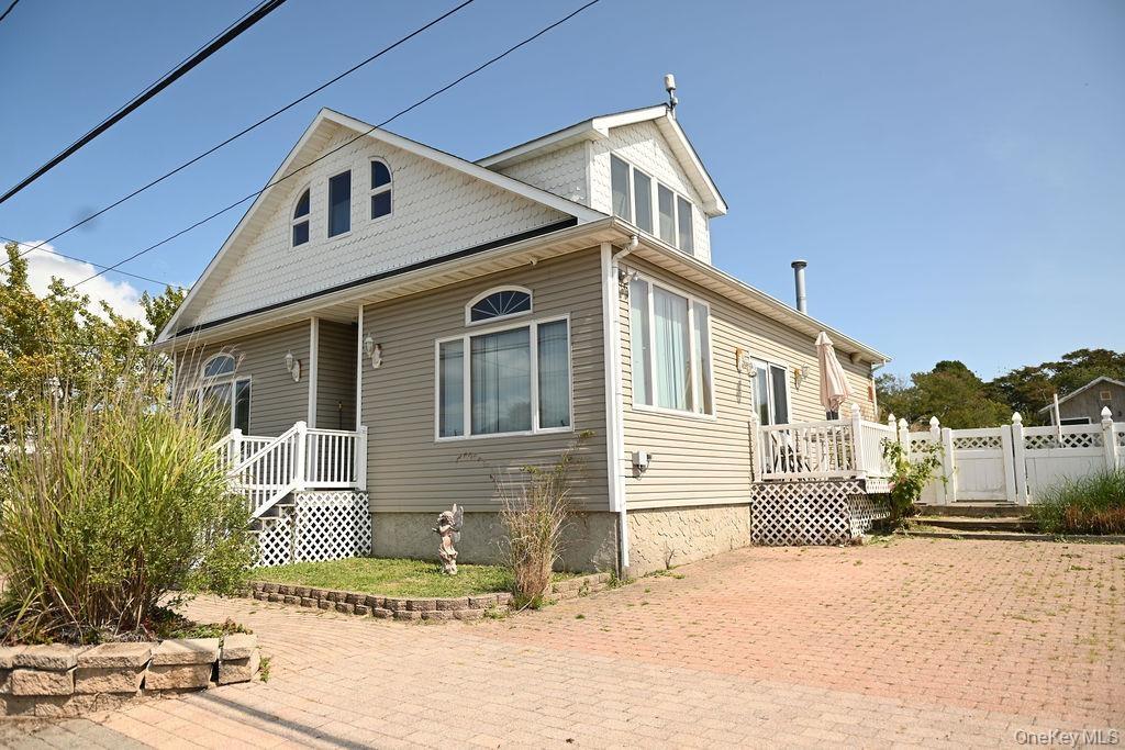 View of front of house featuring a wooden deck