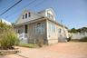View of front of house featuring a wooden deck