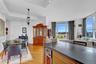 Kitchen featuring light wood-style flooring, open floor plan, wine cooler, dark stone counters, and recessed lighting