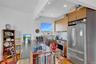 Kitchen featuring stainless steel appliances, light wood finished floors, recessed lighting, decorative backsplash, and open shelves