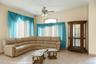 Living area featuring tile patterned floors and ceiling fan