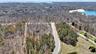 Aerial view featuring a water view and a wooded view