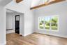 Dining Rm featuring plenty of natural light, light wood-type flooring, baseboards, and high vaulted ceiling
