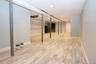 Finished below grade area with light wood-style flooring, oil tank, and recessed lighting