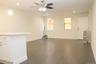 Unfurnished living room featuring recessed lighting, radiator heating unit, dark wood-style floors, and a ceiling fan