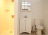 Bathroom featuring a shower stall, vanity, and light wood-style flooring