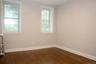 Spare room featuring dark wood finished floors and radiator