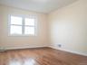 Spare room with visible vents, hardwood / wood-style floors, and baseboards