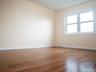 Spare room featuring wood finished floors and baseboards