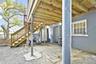 View of patio with fence and stairs