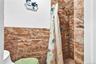 Full bath featuring toilet and a shower stall