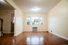 Empty room featuring baseboards, visible vents, a wall unit AC, and hardwood / wood-style flooring