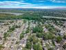 Aerial overview of property's location featuring a nearby body of water and nearby suburban area
