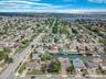 Aerial view of property's location with a nearby body of water and nearby suburban area