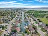 Aerial view of residential area featuring a nearby body of water