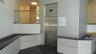 Kitchen with dark tile patterned flooring and white cabinetry