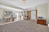Foyer featuring light tile patterned flooring and light colored carpet