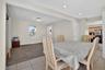 Dining space featuring light colored carpet, a baseboard heating unit, light tile patterned floors, and recessed lighting