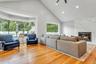 Living room featuring light wood-style floors, high vaulted ceiling, a fireplace, a ceiling fan, and recessed lighting
