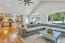 Living area with ceiling fan, high vaulted ceiling, light wood finished floors, and recessed lighting