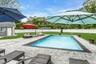 View of swimming pool with a patio, an outdoor structure, and an outdoor living space