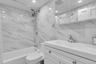 Full bathroom featuring vanity,  shower combination, tile walls, toilet, and recessed lighting