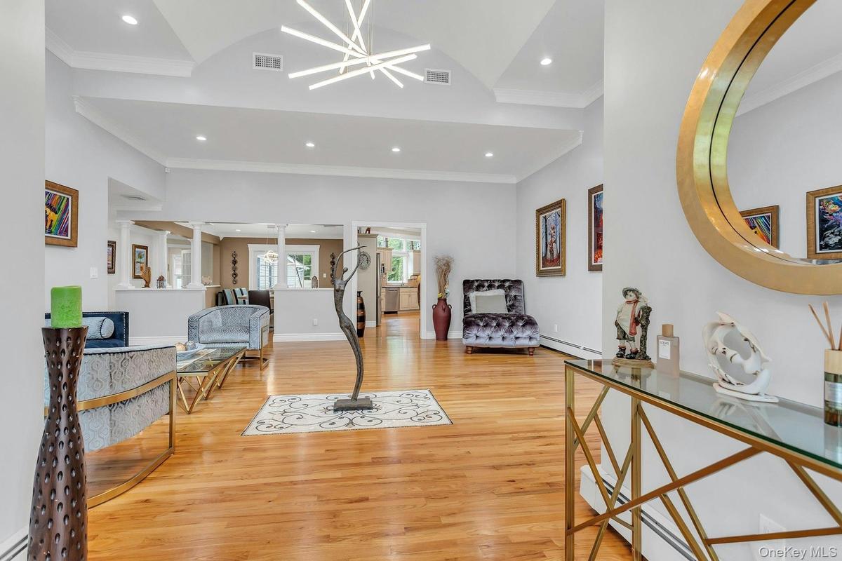 Entryway featuring a baseboard heating unit, ornamental molding, light wood finished floors, recessed lighting, and baseboard heating