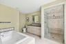 Bathroom with double vanity, a whirlpool tub, a shower stall, recessed lighting, and tile patterned floors