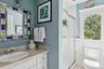 Bathroom featuring a stall shower and vanity