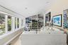 Carpeted living room with vaulted ceiling and baseboards