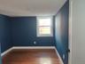 Unfurnished room with dark wood-style flooring and baseboards