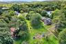 Drone / aerial view of a forest and a nearby body of water