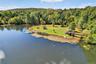 Bird's eye view of a nearby body of water and a heavily wooded area