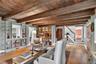 Living area featuring stairs, a wood ceiling with exposed beams, and hardwood / wood-style floors
