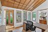 Office area with light wood-style floors and wooden ceiling