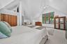 Bedroom with carpet floors, high vaulted ceiling, and a closet