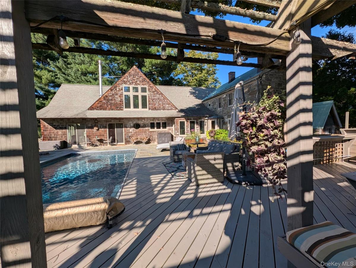 Deck featuring an outdoor pool, and a patio area