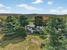 View of property location featuring a forest