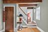 Entryway featuring beamed ceiling, wood finished floors, and stairway