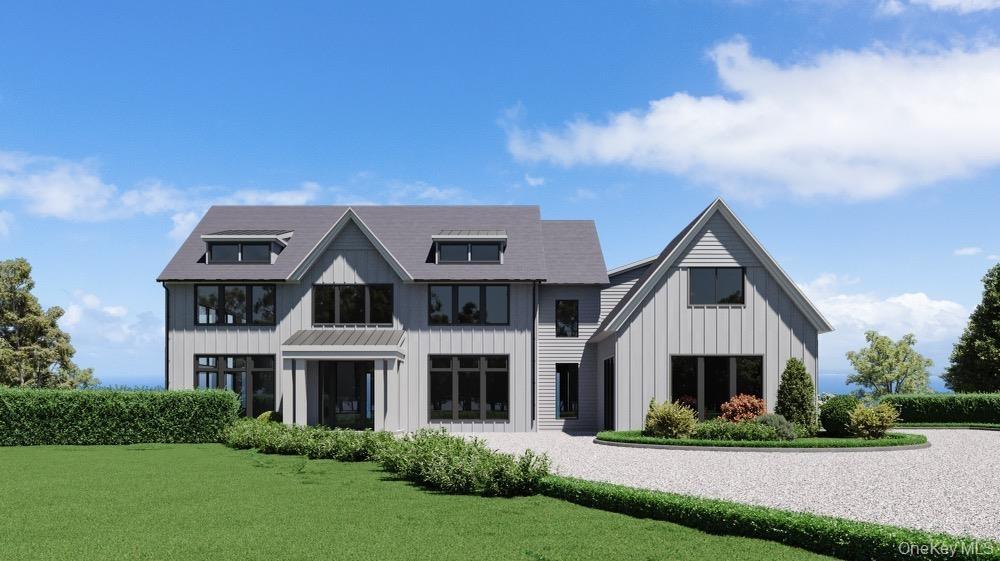 View of front of property featuring board and batten siding and a front yard