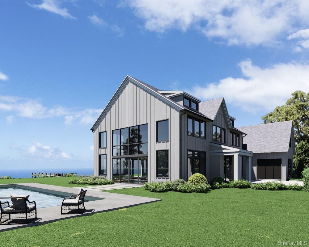 Rear view of house featuring board and batten siding, a lawn, an outdoor pool, and roof with shingles