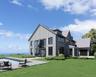 Rear view of house featuring board and batten siding, a lawn, an outdoor pool, and roof with shingles