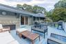 Wooden terrace featuring grilling area and an outdoor living space