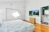 Bedroom with high vaulted ceiling, sink, light hardwood / wood-style floors, ensuite bath, and a closet